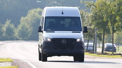 Woman in van checking navigation before long road trip.