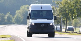 Woman in van checking navigation before long road trip.